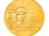 gold coin with the image of the statue of liberty on it