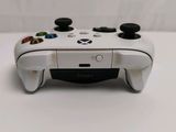 a close up of a white controller on a table