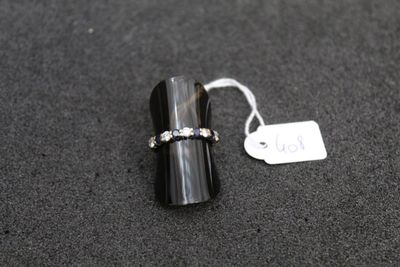 a ring that is sitting on a table next to a price tag