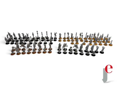 a group of small metal figurines sitting on top of a white surface