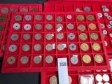 many different types of coins in a red box