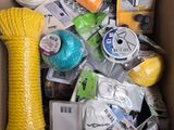 a cardboard box filled with various items that include yarn, scissors, scissors, and other items