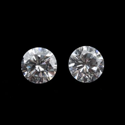 two round brilliant cut diamonds on a black background