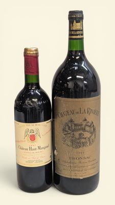 deux bouteilles de vin posées l'une à côté de l'autre sur une surface blanche