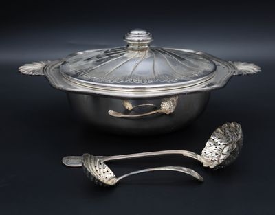 a silver pot with a lid and two spoons next to it