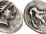 a silver coin with a woman ' s head and a man ' s head on it