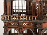 a wooden bird cage with a bird inside of it