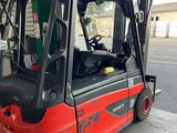 a red fork truck parked in front of a building