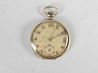an antique pocket watch on a white surface with a white background