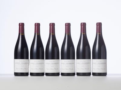 six bottles of red wine lined up in a row