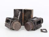 two old cameras sitting next to each other on a white surface