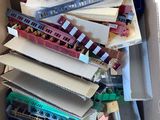 a cardboard box full of toy trains and other toys