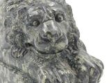 a statue of a lion that is sitting on the ground