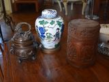 a wooden table with a vase and other items on it