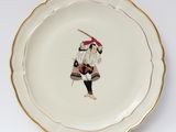a plate with a picture of a man holding a baseball bat