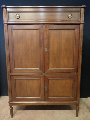 a wooden cabinet with drawers and drawers on top of it