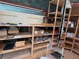 a room with shelves, shelves, and a shopping cart in it