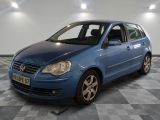 blue car parked in a room with checkered floor and white walls