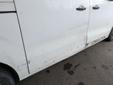 a white van that is parked on the side of the road