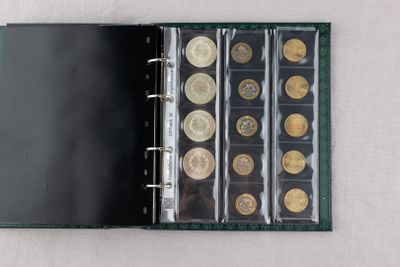 a black binder with a bunch of coins in it
