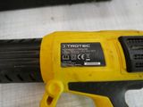 a yellow and black corded drill on a white surface