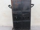 a black metal cabinet with a door on top of it