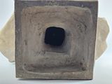 a concrete sculpture with a hole in the middle of it