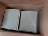 deux livres dans une boîte en carton posée par terre