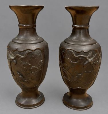 pair of antique bronze vases with floral designs on the sides
