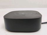 a black device sitting on a white surface