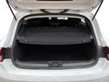 the back of a white car with its trunk open showing the cargo compartment