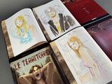 several books with drawings of a woman and a man on them