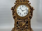a gold clock that is sitting on a table