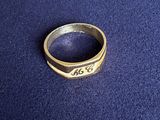 a gold ring with the word arg on it