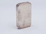 an antique silver plated lighter with a rectangular shape on a white background