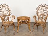 two chairs and a table in a room with a white wall