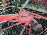 a red machine that is sitting in the grass