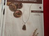 magazine with a picture of a necklace and a brochure on a table