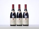 three bottles of wine sitting on top of a table next to each other