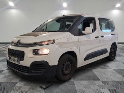 the white van is parked on a checkered floor in a room