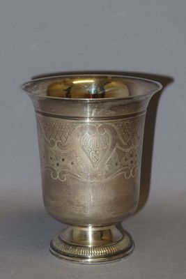 a silver cup that is sitting on a table