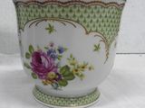 a close up of a cup with flowers on it