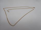 un collier en or avec une chaîne sur fond blanc