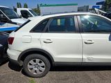 a white car parked in a parking lot with other cars