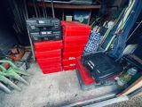 many red boxes stacked on top of each other in a garage