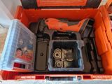 an orange tool box with tools in it sitting on the floor