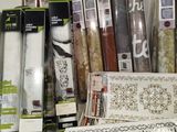 a lot of different types of wallpapers on the shelf