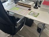 a desk with a computer and a chair in front of it