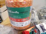 a spool of orange and green yarn next to a package of scissors