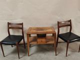 three chairs and a table in the corner of a room